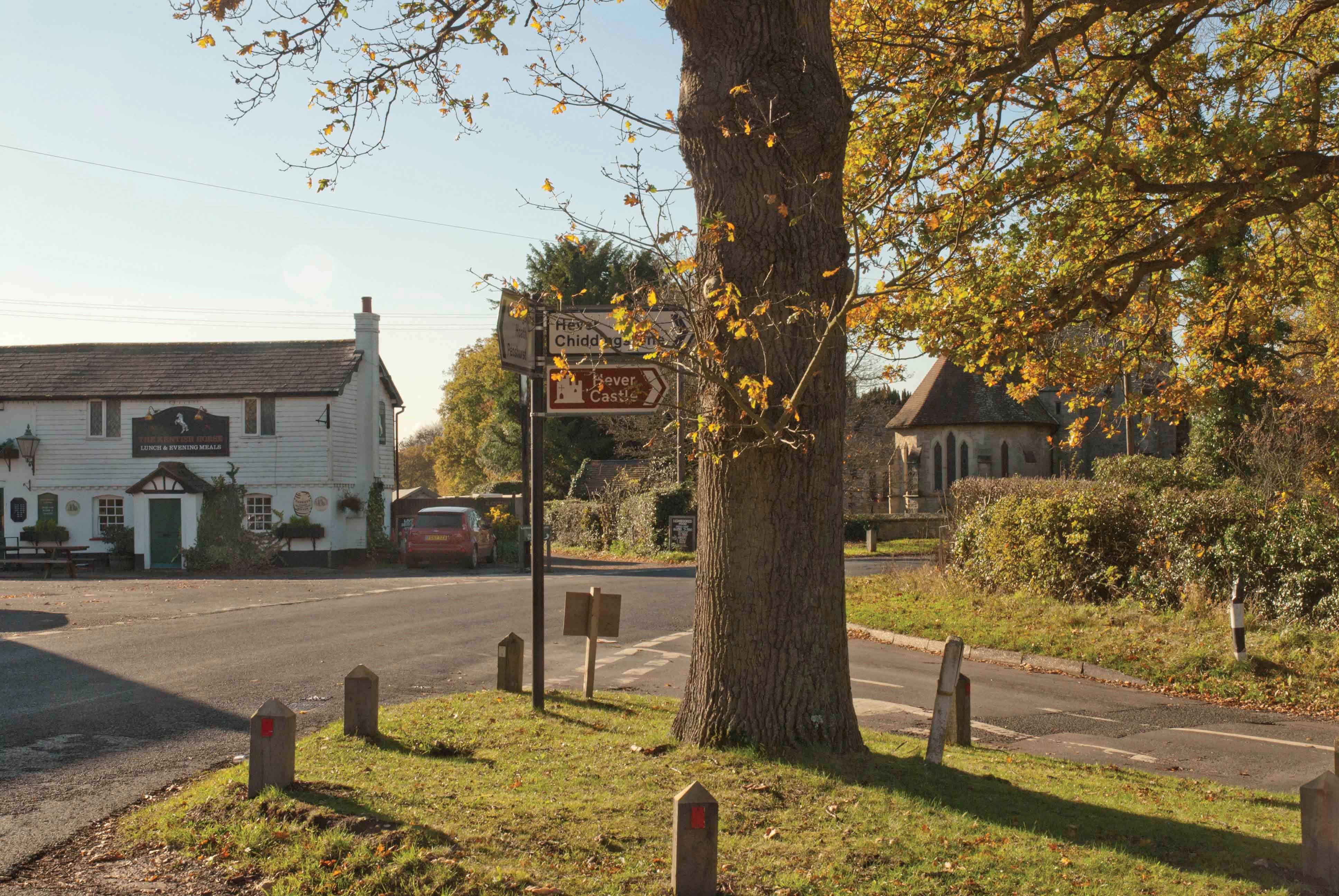 Signpost to Hever Castle and Chiddingstone at the village crossroads, with The Castle Inn behind