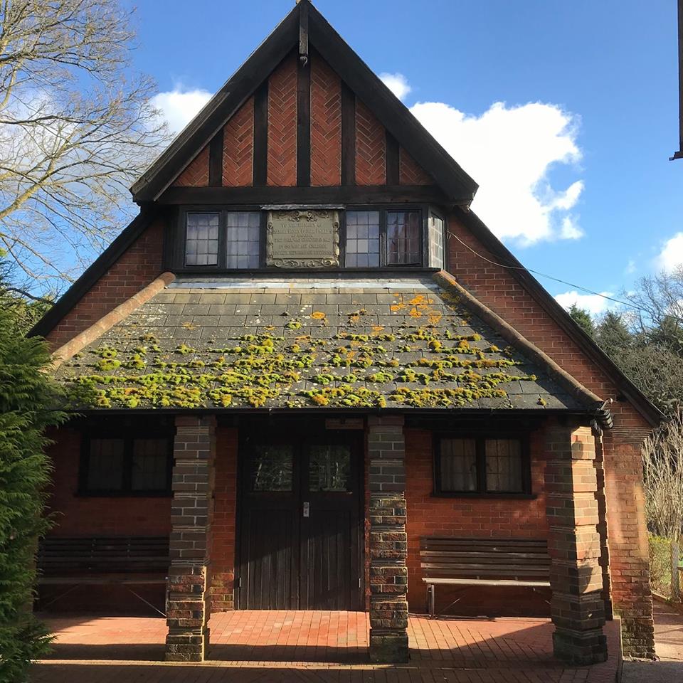 Four Elms Village Hall, a red-brick hall with a mossy tiled gable roof and covered porch entrance